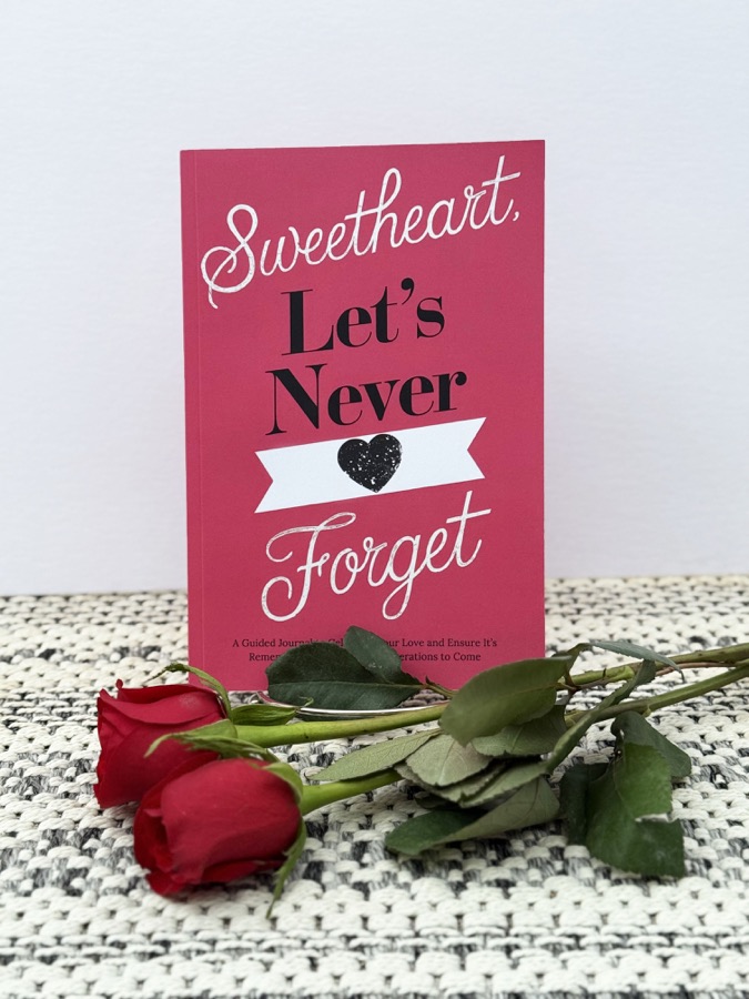 Sweetheart, Let's Never Forget journal standing with two red roses